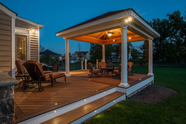 outdoor pavilion at night with spot lights and patio furniture