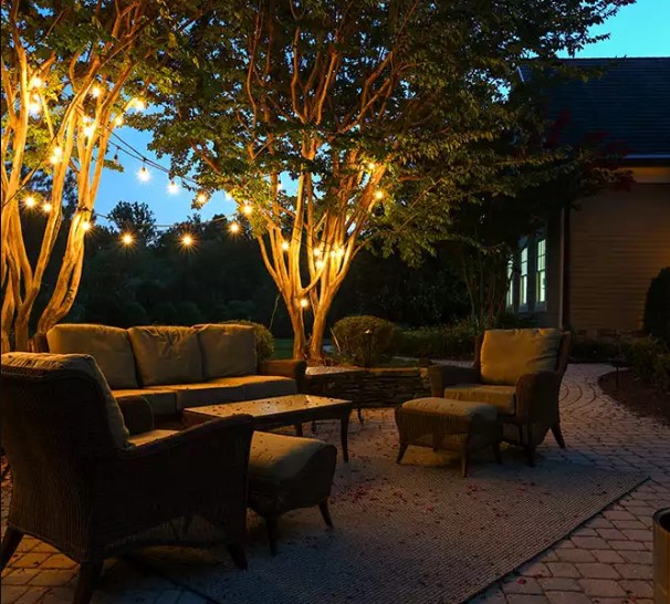 landscape installation with patio furniture and hanging lights